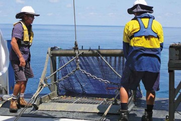 Researchers launching an epibenthic sled from ship deck.